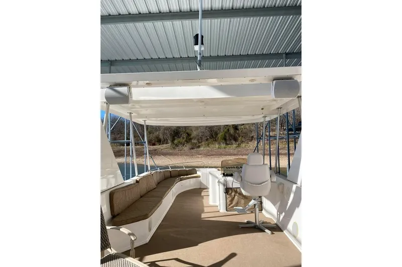 Slide: The Image of Spacious deck of 2007 Summerset houseboat with lounge chairs and helm station. - 70
