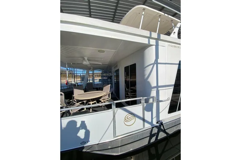 Slide: The Image of Luxurious living area in 2007 Summerset houseboat with leather sofa and large windows. - 81
