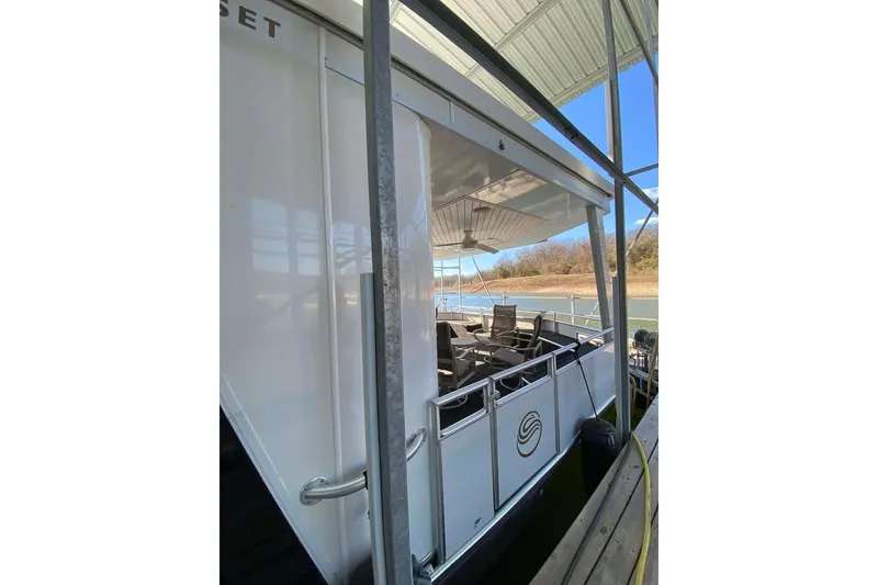 Slide: The Image of 2007 Summerset houseboat, 21' x 106', docked with sleek windows and modern design. - 85