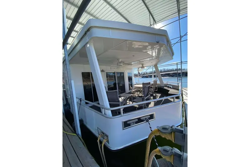 Slide: The Image of Summerset 21' x 106' houseboat, 2007 model, docked under a metal canopy. - 86