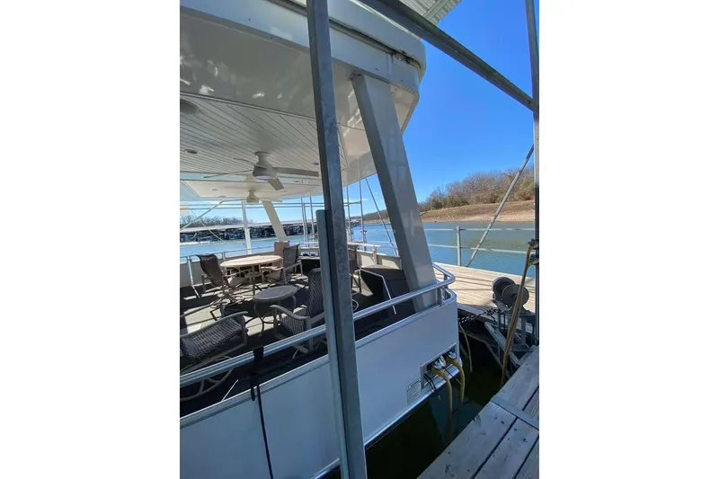 Slide: The Image of Summerset 21' x 106' houseboat, 2007 model, docked with outdoor seating area. - 88