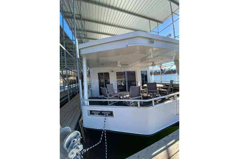 Slide: The Image of 2007 Summerset houseboat, 21' x 106', docked with outdoor seating area. - 89