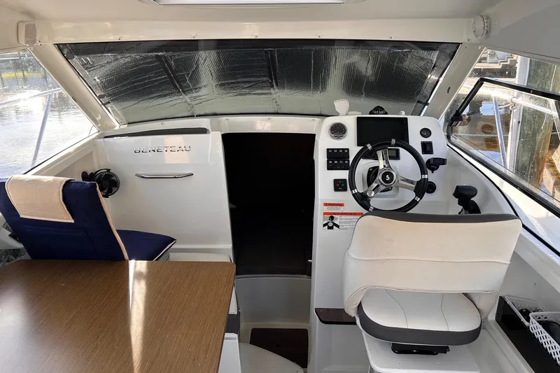 Slide: The Image of Interior of 2021 Beneteau Antares 8 boat, featuring helm and seating area. - 14