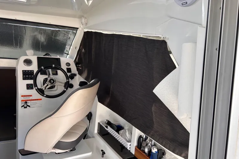 Slide: The Image of Interior helm of 2021 Beneteau Antares 8 with steering wheel and controls. - 15