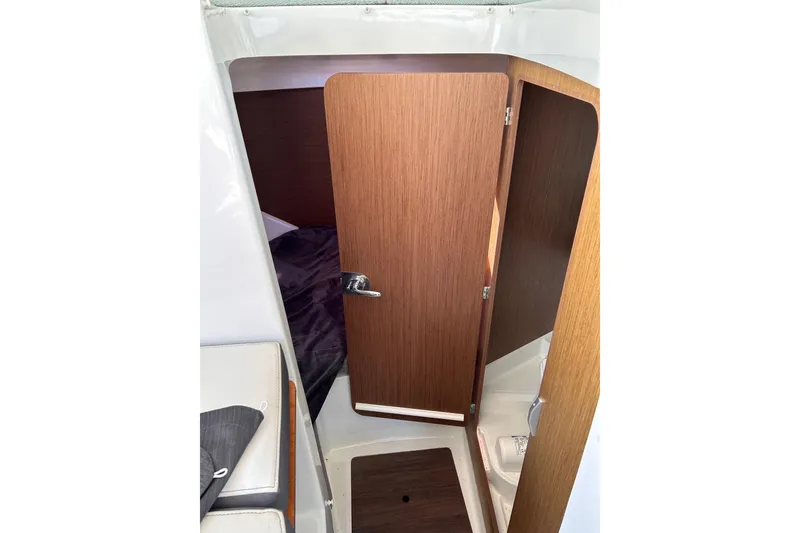 Slide: The Image of Interior cabin view of 2021 Beneteau Antares 8 with wooden door and seating. - 20