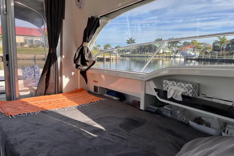 Slide: The Image of Interior view of 2021 Beneteau Antares 8 cabin with waterfront scenery. - 24