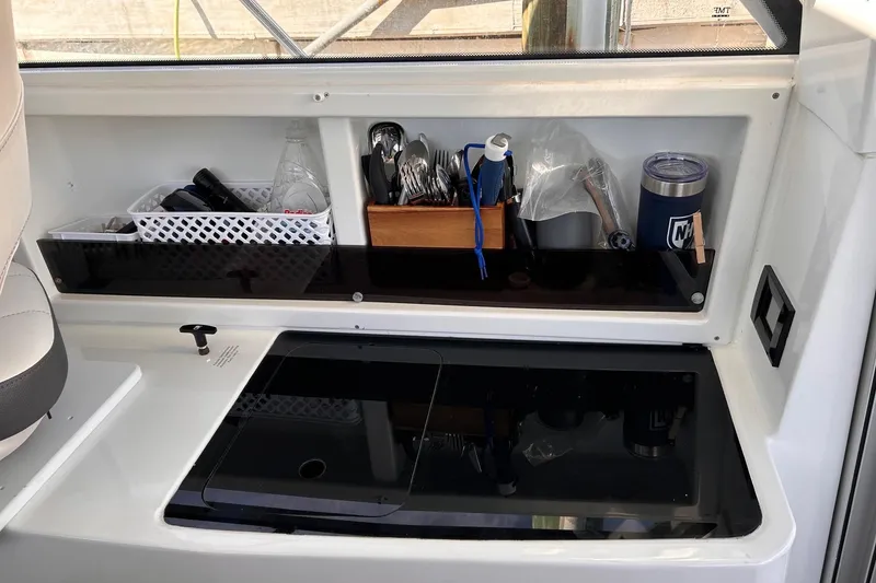 Slide: The Image of Interior view of 2021 Beneteau Antares 8 with organized storage and kitchen area. - 26