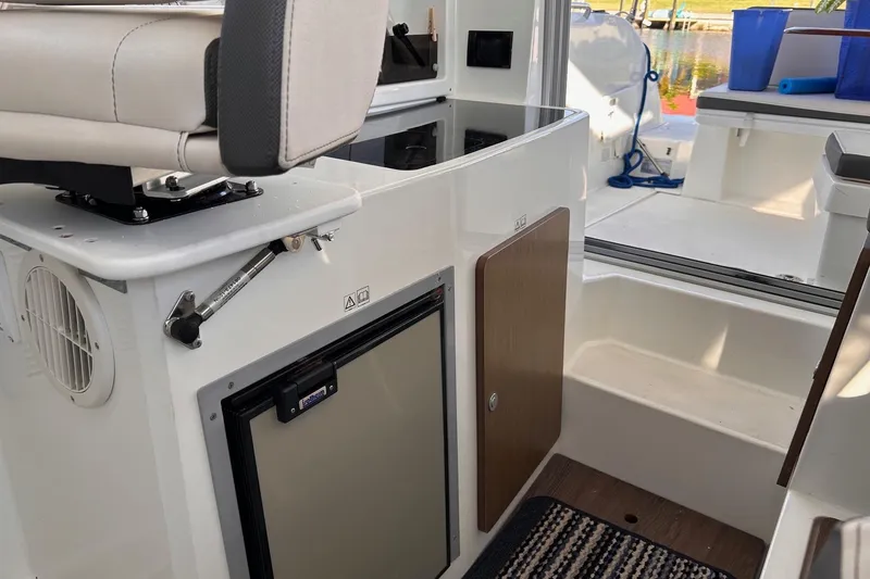 Slide: The Image of Interior of 2021 Beneteau Antares 8 boat, featuring seating and storage compartments. - 28