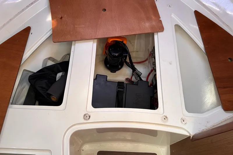 Slide: The Image of Storage compartment of a 2021 Beneteau Antares 8 boat, showing equipment and wiring. - 35