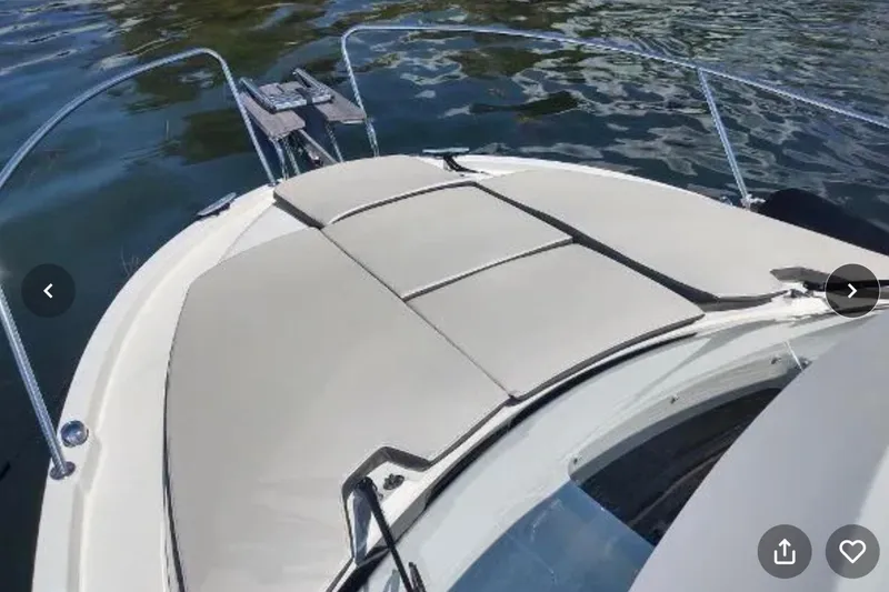 Slide: The Image of 2021 Beneteau Antares 8 boat with cushioned deck, anchored on calm water. - 5