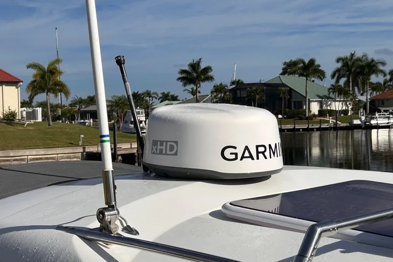 Slide: The Image of Beneteau Antares 8 (2021) with Garmin xHD radar, docked near palm trees. - 8