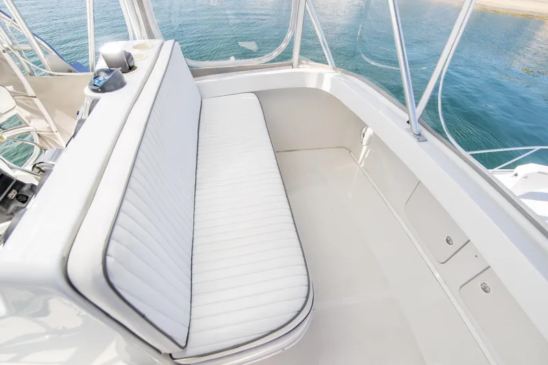 Slide: The Image of 2002 Luhrs 36 Convertible boat interior with white seating and ocean view. - 10