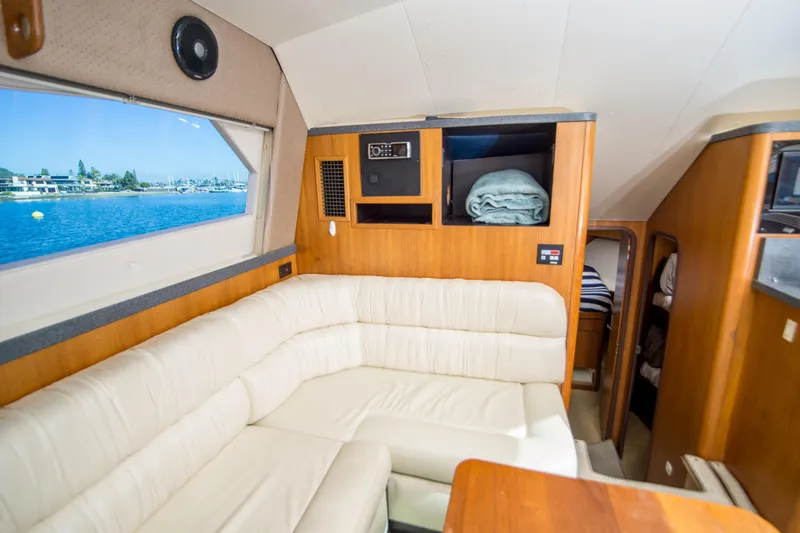 Slide: The Image of 2002 Luhrs 36 Convertible yacht interior with cream leather seating and ocean view. - 15