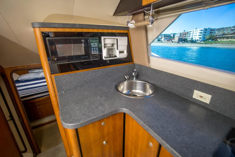 Slide: The Image of 2002 Luhrs 36 Convertible yacht interior with kitchenette, sink, and ocean view. - 18