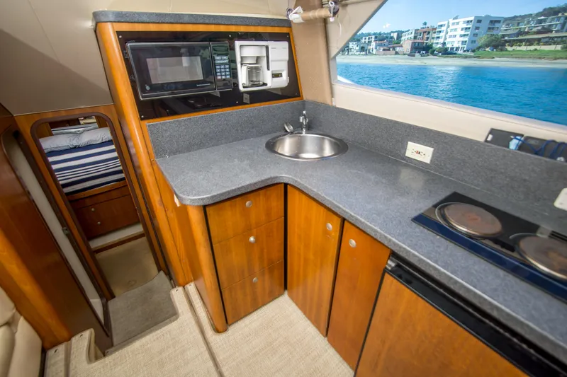 Slide: The Image of 2002 Luhrs 36 Convertible yacht kitchen with modern appliances and ocean view. - 19