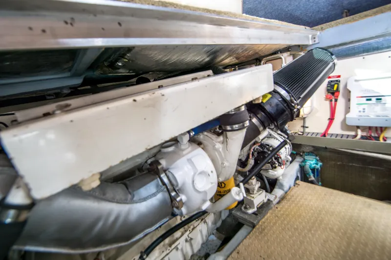 Slide: The Image of Engine room of 2002 Luhrs 36 Convertible boat, showcasing mechanical components and wiring. - 24