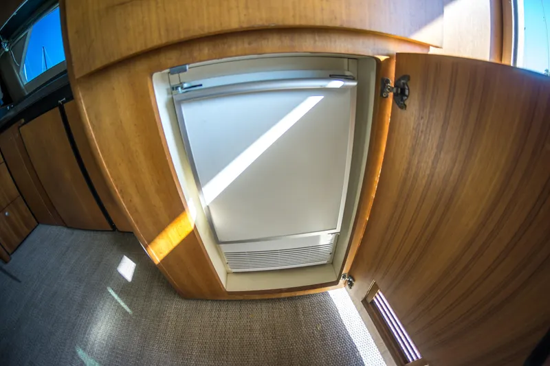 Slide: The Image of Wooden interior of 2002 Luhrs 36 Convertible yacht with built-in refrigerator. - 30