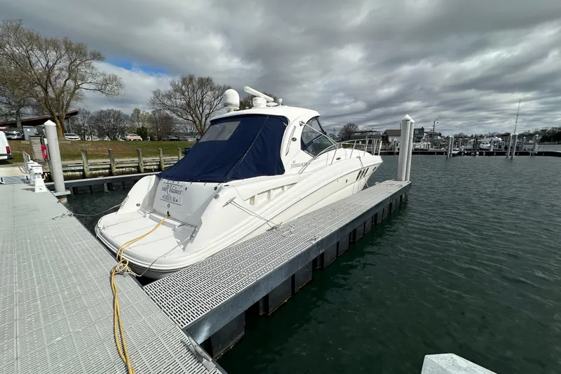 Slide: The Image of 2007 Sea Ray 40 Sundancer yacht on land, surrounded by covered boats. - 10