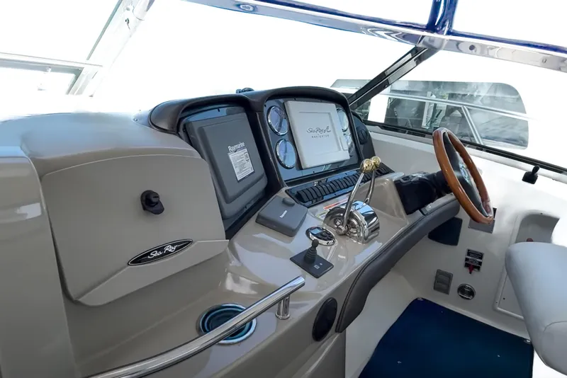 Slide: The Image of Helm of 2007 Sea Ray 40 Sundancer with steering wheel and navigation controls. - 17