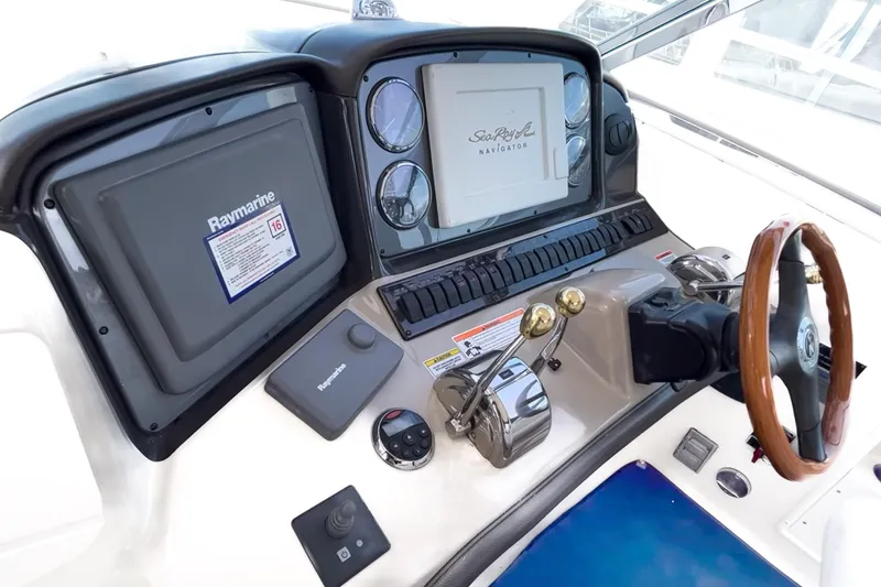 Slide: The Image of 2007 Sea Ray 40 Sundancer helm with Raymarine navigation system and wooden steering wheel. - 18