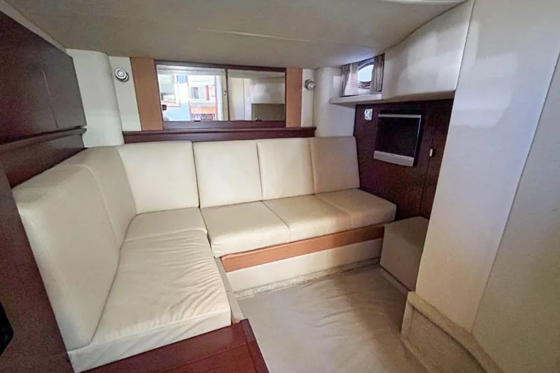 Slide: The Image of Interior of 2007 Sea Ray 40 Sundancer yacht with beige seating and small TV. - 28