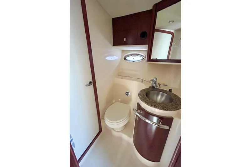 Slide: The Image of 2007 Sea Ray 40 Sundancer yacht bathroom with sink, toilet, and mirror. - 29