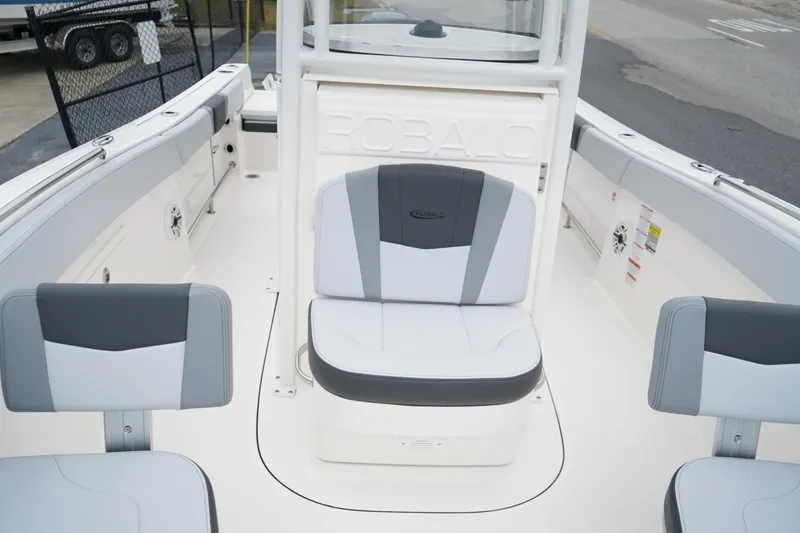 Slide: The Image of 2026 Robalo R232 Explorer boat interior with gray and white seating. - 13