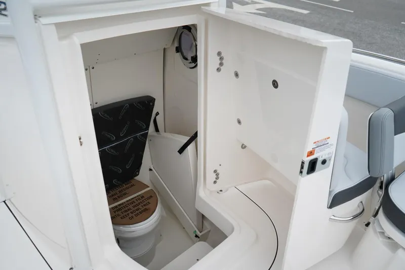 Slide: The Image of 2026 Robalo R232 Explorer boat interior with compact marine toilet. - 14