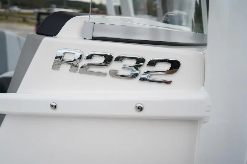 Slide: The Image of 2026 Robalo R232 Explorer boat emblem on white surface. - 15