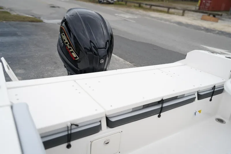 Slide: The Image of 2026 Robalo R232 Explorer boat with Yamaha outboard motor, docked on pavement. - 16