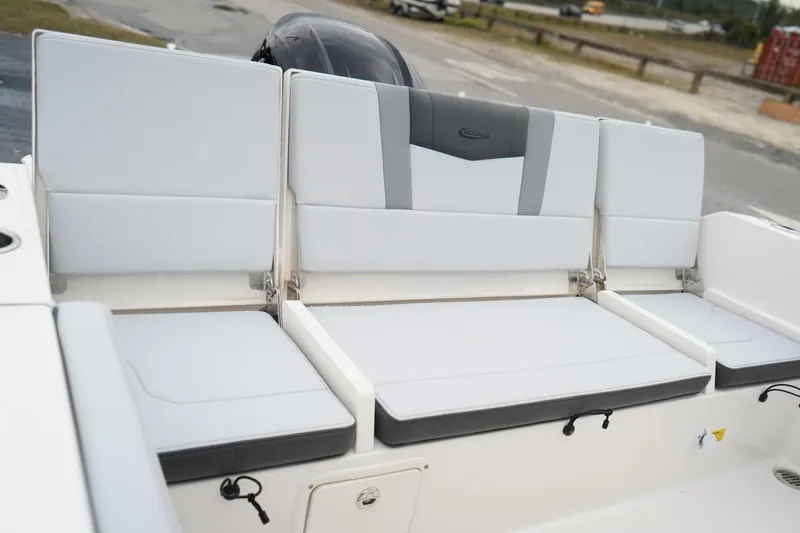 Slide: The Image of 2026 Robalo R232 Explorer boat seating, featuring sleek white and gray upholstery. - 17