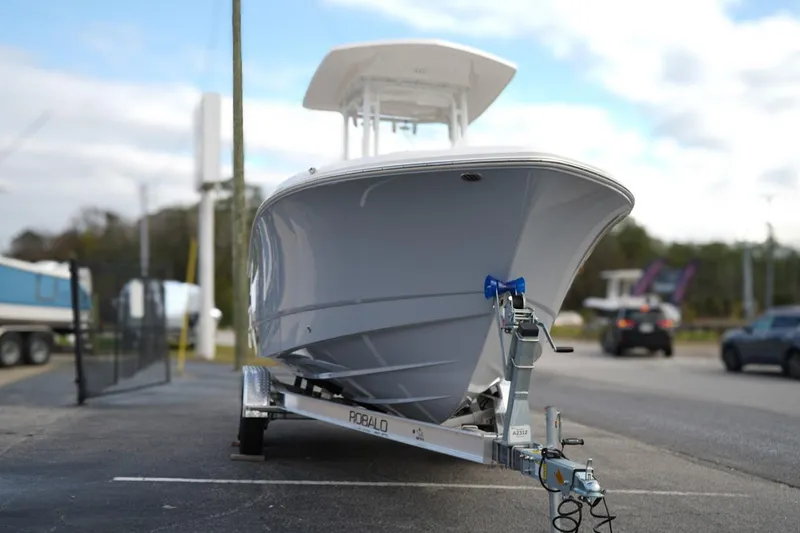 Slide: The Image of 2026 Robalo R232 Explorer boat on trailer, parked outdoors. - 2