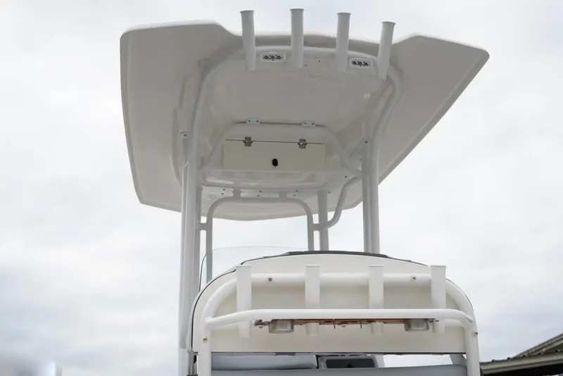 Slide: The Image of 2026 Robalo R232 Explorer boat with T-top and rod holders, viewed from below. - 22