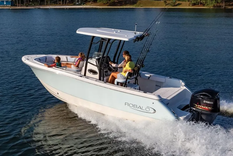 Slide: The Image of Manufacturer Provided Image: 2025 Robalo R232 Explorer boat cruising on a lake with passengers onboard. - 25