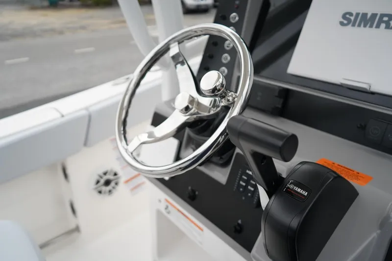 Slide: The Image of 2026 Robalo R232 Explorer boat helm with Yamaha controls and Simrad display. - 6