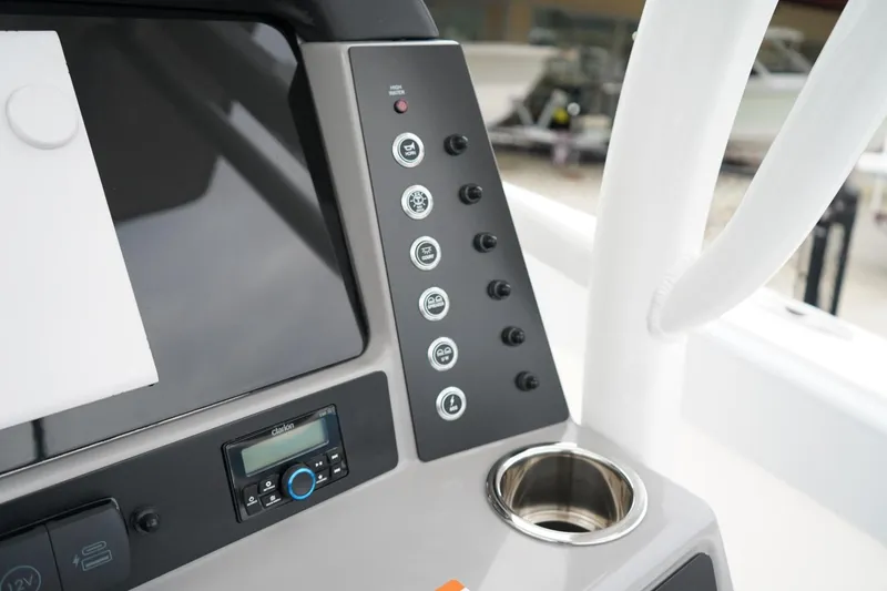 Slide: The Image of Control panel of 2026 Robalo R232 Explorer boat with cup holder and electronic display. - 7