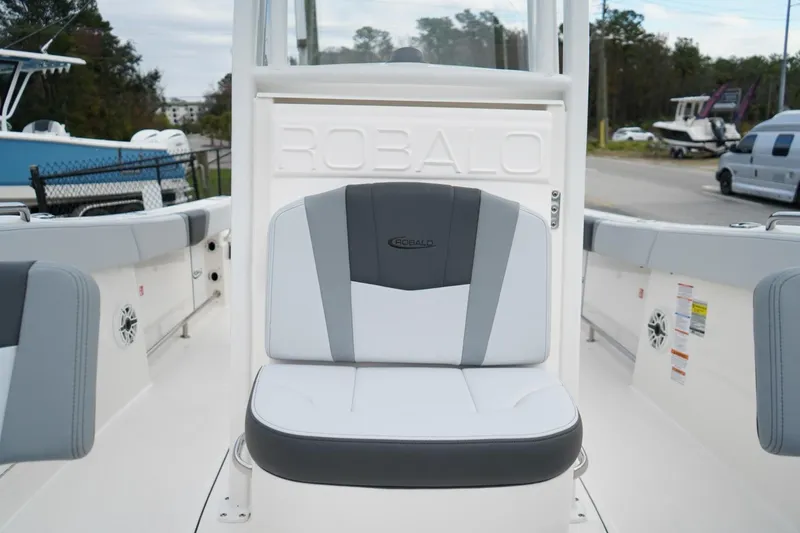 Slide: The Image of 2026 Robalo R232 Explorer boat interior with cushioned seating and branded backrest. - 9