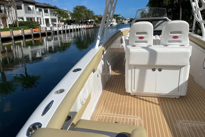 Slide: The Image of 2014 Powerplay Powerboats 35 Open on a scenic waterfront, showcasing luxury seating and sleek design. - 11