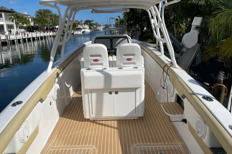 Slide: The Image of 2014 Powerplay Powerboats 35 Open, sleek design, spacious deck, docked by waterfront homes. - 12