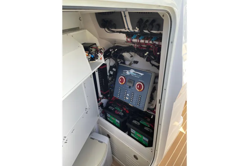 Slide: The Image of Electrical system inside a 2014 Powerplay Powerboats 35 Open, showcasing wiring and battery setup. - 14