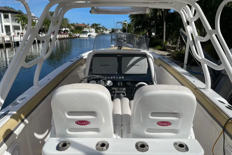 Slide: The Image of 2014 Powerplay Powerboats 35 Open with dual Garmin displays, docked in a scenic canal. - 15