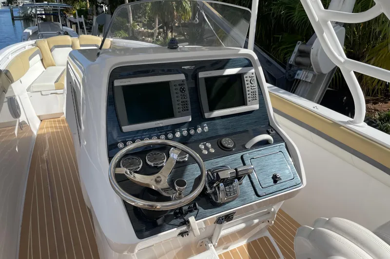 Slide: The Image of 2014 Powerplay Powerboats 35 Open dashboard with dual screens and steering wheel. - 17