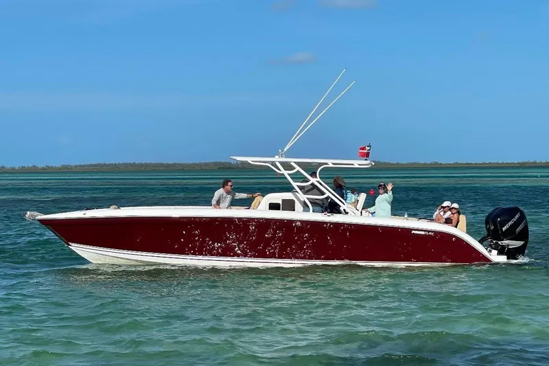 Slide: The Image of 2014 Powerplay Powerboats 35 Open cruising on clear blue waters. - 2