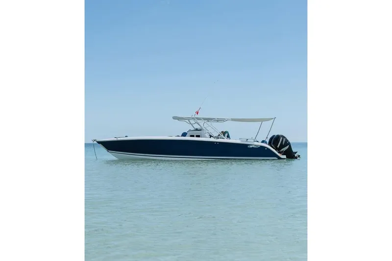 Slide: The Image of 2014 Powerplay Powerboats 35 Open on calm water, featuring sleek design and twin engines. - 25