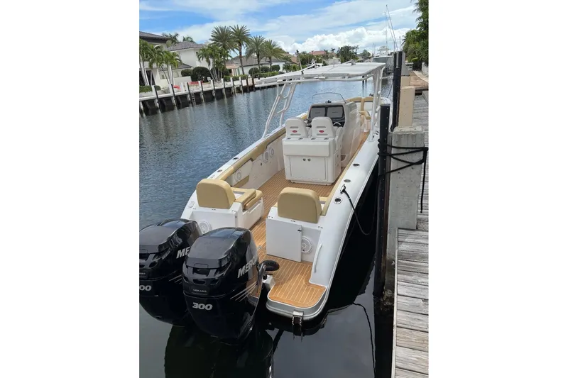 Slide: The Image of 2014 Powerplay Powerboats 35 Open docked, featuring dual Mercury engines. - 4