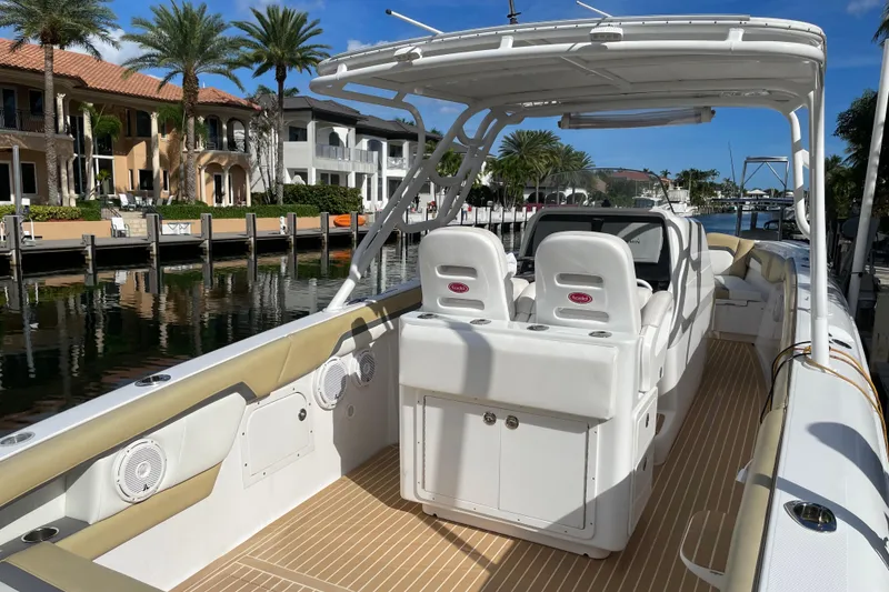 Slide: The Image of 2014 Powerplay Powerboats 35 Open, luxury boat interior, docked by waterfront homes. - 6