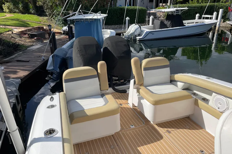 Slide: The Image of 2014 Powerplay Powerboats 35 Open docked, featuring beige and white seating, dual engines. - 7