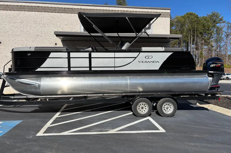 The Image of 2026 Veranda Relax VR 22 VLC pontoon boat on trailer, parked outdoors. - 0