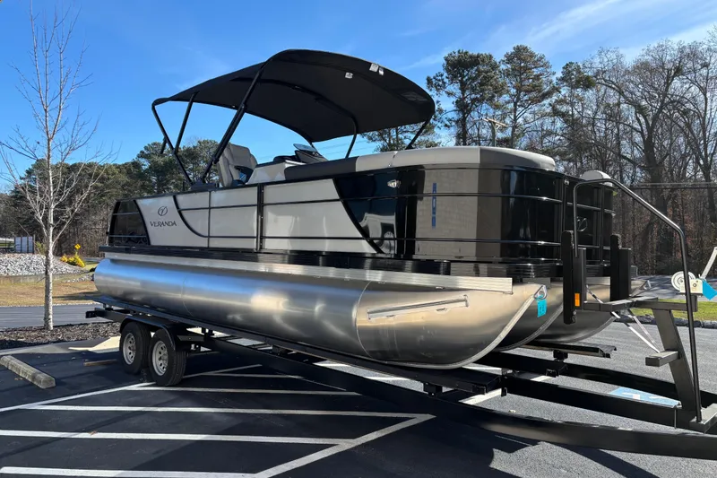 Slide: The Image of 2026 Veranda Relax VR 22 VLC pontoon boat on trailer in parking lot. - 2
