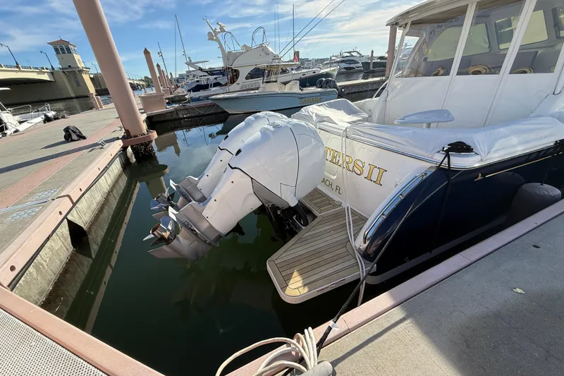 Slide: The Image of 2022 Back Cove 34O boat docked with dual outboard engines. - 18